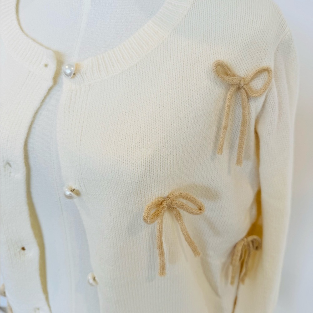 Elegant Cream Sweater with Bow Accents